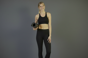 Women in yoga studio holding yoga mat wearing organic cotton leggings, tights full length 
